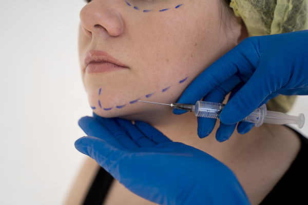close up hands giving injection young woman