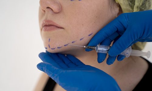 close up hands giving injection young woman